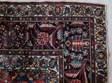 Antique Persian area rug in a living room setting, pile rug, vintage rug, portland, rug shop, bright colors, wild shaman, soft rug, bold color, Portland, Oregon, rug store, rug shop, local shop, antique rug, Persian rug, handmade rug, wool rug, distressed rug
