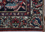 Antique Persian area rug in a living room setting, pile rug, vintage rug, portland, rug shop, bright colors, wild shaman, soft rug, bold color, Portland, Oregon, rug store, rug shop, local shop, antique rug, Persian rug, handmade rug, wool rug, distressed rug