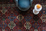 Antique Persian area rug in a living room setting, pile rug, vintage rug, portland, rug shop, bright colors, wild shaman, soft rug, bold color, Portland, Oregon, rug store, rug shop, local shop, antique rug, Persian rug, handmade rug, wool rug, distressed rug