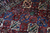 Antique Persian area rug in a living room setting, pile rug, vintage rug, portland, rug shop, bright colors, wild shaman, soft rug, bold color, Portland, Oregon, rug store, rug shop, local shop, antique rug, Persian rug, handmade rug, wool rug, distressed rug