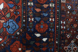Antique Persian area rug in a living room setting, pile rug, vintage rug, portland, rug shop, bright colors, wild shaman, soft rug, bold color, Portland, Oregon, rug store, rug shop, local shop, antique rug, Persian rug, handmade rug, wool rug, distressed rug
