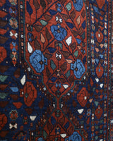 Antique Persian area rug in a living room setting, pile rug, vintage rug, portland, rug shop, bright colors, wild shaman, soft rug, bold color, Portland, Oregon, rug store, rug shop, local shop, antique rug, Persian rug, handmade rug, wool rug, distressed rug