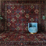 Antique Persian area rug in a living room setting, pile rug, vintage rug, portland, rug shop, bright colors, wild shaman, soft rug, bold color, Portland, Oregon, rug store, rug shop, local shop, antique rug, Persian rug, handmade rug, wool rug, distressed rug