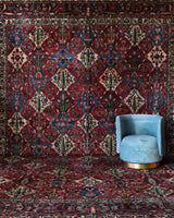 Antique Persian area rug in a living room setting, pile rug, vintage rug, portland, rug shop, bright colors, wild shaman, soft rug, bold color, Portland, Oregon, rug store, rug shop, local shop, antique rug, Persian rug, handmade rug, wool rug, distressed rug