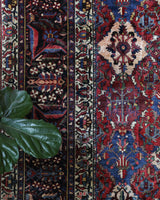 Antique Persian area rug in a living room setting, pile rug, vintage rug, portland, rug shop, bright colors, wild shaman, soft rug, bold color, Portland, Oregon, rug store, rug shop, local shop, antique rug, Persian rug, handmade rug, wool rug, distressed rug