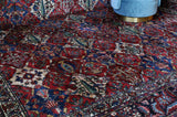 Antique Persian area rug in a living room setting, pile rug, vintage rug, portland, rug shop, bright colors, wild shaman, soft rug, bold color, Portland, Oregon, rug store, rug shop, local shop, antique rug, Persian rug, handmade rug, wool rug, distressed rug