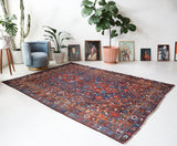Antique Persian area rug in a living room setting, pile rug, vintage rug, portland, rug shop, bright colors, wild shaman, soft rug, bold color, Portland, Oregon, rug store, rug shop, local shop, antique rug, Persian rug, handmade rug, wool rug, distressed rug