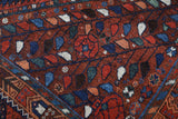 Antique Persian area rug in a living room setting, pile rug, vintage rug, portland, rug shop, bright colors, wild shaman, soft rug, bold color, Portland, Oregon, rug store, rug shop, local shop, antique rug, Persian rug, handmade rug, wool rug, distressed rug