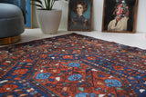 Antique Persian area rug in a living room setting, pile rug, vintage rug, portland, rug shop, bright colors, wild shaman, soft rug, bold color, Portland, Oregon, rug store, rug shop, local shop, antique rug, Persian rug, handmade rug, wool rug, distressed rug