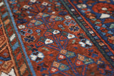Antique Persian area rug in a living room setting, pile rug, vintage rug, portland, rug shop, bright colors, wild shaman, soft rug, bold color, Portland, Oregon, rug store, rug shop, local shop, antique rug, Persian rug, handmade rug, wool rug, distressed rug