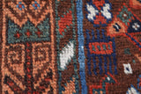 Antique Persian area rug in a living room setting, pile rug, vintage rug, portland, rug shop, bright colors, wild shaman, soft rug, bold color, Portland, Oregon, rug store, rug shop, local shop, antique rug, Persian rug, handmade rug, wool rug, distressed rug