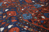 Antique Persian area rug in a living room setting, pile rug, vintage rug, portland, rug shop, bright colors, wild shaman, soft rug, bold color, Portland, Oregon, rug store, rug shop, local shop, antique rug, Persian rug, handmade rug, wool rug, distressed rug