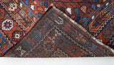 Antique Persian area rug in a living room setting, pile rug, vintage rug, portland, rug shop, bright colors, wild shaman, soft rug, bold color, Portland, Oregon, rug store, rug shop, local shop, antique rug, Persian rug, handmade rug, wool rug, distressed rug