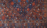 Antique Persian area rug in a living room setting, pile rug, vintage rug, portland, rug shop, bright colors, wild shaman, soft rug, bold color, Portland, Oregon, rug store, rug shop, local shop, antique rug, Persian rug, handmade rug, wool rug, distressed rug