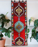 Vintage Turkish runner rug in a living room setting, pile rug, Turkish rug, vintage rug, portland, rug shop, bright colors, wild shaman, soft rug, bold color, Portland, Oregon, rug store, rug shop, local shop, antique rug