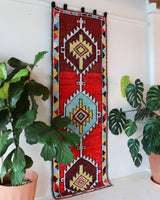 Vintage Turkish runner rug in a living room setting, pile rug, Turkish rug, vintage rug, portland, rug shop, bright colors, wild shaman, soft rug, bold color, Portland, Oregon, rug store, rug shop, local shop, antique rug