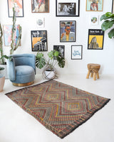 Vintage kilim rug in living room setting, old rug, antique rug, pastel colors, faded colors, Turkish rug, vintage rug, soft rug, Portland, Oregon, rug store, rug shop, local shop, earthy tones, earthy colors, warm colors
