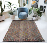 Vintage kilim rug in living room setting, old rug, antique rug, pastel colors, faded colors, Turkish rug, vintage rug, soft rug, Portland, Oregon, rug store, rug shop, local shop, earthy tones, earthy colors, warm colors