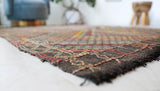 Vintage kilim rug in living room setting, old rug, antique rug, pastel colors, faded colors, Turkish rug, vintage rug, soft rug, Portland, Oregon, rug store, rug shop, local shop, earthy tones, earthy colors, warm colors