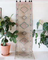 Vintage Turkish runner rug in living room setting, old rug, antique rug, pastel colors, faded colors, Turkish rug, vintage rug, soft rug, Portland, Oregon, rug store, rug shop, local shop