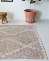 Vintage kilim rug in living room setting, old rug, antique rug, pastel colors, faded colors, Turkish rug, vintage rug, soft rug, Portland, Oregon, rug store, rug shop, local shop, earthy tones, earthy colors, warm colors