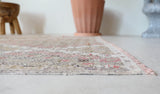 Vintage kilim rug in living room setting, old rug, antique rug, pastel colors, faded colors, Turkish rug, vintage rug, soft rug, Portland, Oregon, rug store, rug shop, local shop, earthy tones, earthy colors, warm colors
