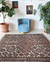 Vintage kilim rug in living room setting, old rug, antique rug, pastel colors, faded colors, Turkish rug, vintage rug, soft rug, Portland, Oregon, rug store, rug shop, local shop, earthy tones, earthy colors, warm colors