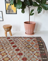 Vintage kilim rug in room decor setting, old rug, antique rug, pastel colors, faded colors, Turkish rug, vintage rug, soft rug, Portland, Oregon, rug store, rug shop, local shop, bold colors, bright colors, faded colors