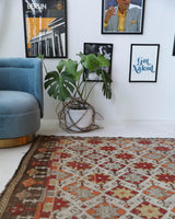 Vintage kilim rug in room decor setting, old rug, antique rug, pastel colors, faded colors, Turkish rug, vintage rug, soft rug, Portland, Oregon, rug store, rug shop, local shop, bold colors, bright colors, faded colors