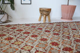 Vintage kilim rug in room decor setting, old rug, antique rug, pastel colors, faded colors, Turkish rug, vintage rug, soft rug, Portland, Oregon, rug store, rug shop, local shop, bold colors, bright colors, faded colors