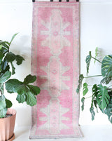 Vintage Turkish runner rug in living room setting, old rug, antique rug, pastel colors, faded colors, Turkish rug, vintage rug, soft rug, Portland, Oregon, rug store, rug shop, local shop