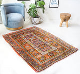 Vintage Turkish rug in a living room setting, pile rug, Turkish rug, vintage rug, portland, rug shop, bright colors, wild shaman, soft rug, bold color, Portland, Oregon, rug store, rug shop, local shop, antique rug