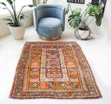 Vintage Turkish rug in a living room setting, pile rug, Turkish rug, vintage rug, portland, rug shop, bright colors, wild shaman, soft rug, bold color, Portland, Oregon, rug store, rug shop, local shop, antique rug