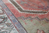 Vintage Turkish rug in living room setting, old rug, antique rug, pastel colors, faded colors, Turkish rug, vintage rug, soft rug, Portland, Oregon, rug store, rug shop, local shop