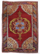 Vintage Turkish rug in a living room setting, pile rug, Turkish rug, vintage rug, portland, rug shop, bright colors, wild shaman, soft rug, bold color, Portland, Oregon, rug store, rug shop, local shop, antique rug