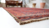 Antique Turkmen rug in a living room setting, pile rug, Turkish rug, vintage rug, portland, rug shop, bright colors, wild shaman, soft rug, bold color, Portland, Oregon, rug store, rug shop, local shop, antique rug