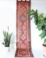 Vintage Turkish runner rug in a living room setting, pile rug, Turkish rug, vintage rug, portland, rug shop, bright colors, wild shaman, soft rug, bold color, Portland, Oregon, rug store, rug shop, local shop