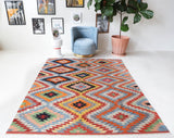 Vintage kilim rug in room decor setting, old rug, antique rug, pastel colors, faded colors, Turkish rug, vintage rug, soft rug, Portland, Oregon, rug store, rug shop, local shop, bold colors, bright colors, faded colors
