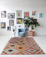 Vintage kilim rug in room decor setting, old rug, antique rug, pastel colors, faded colors, Turkish rug, vintage rug, soft rug, Portland, Oregon, rug store, rug shop, local shop, bold colors, bright colors, faded colors
