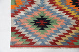 Vintage kilim rug in room decor setting, old rug, antique rug, pastel colors, faded colors, Turkish rug, vintage rug, soft rug, Portland, Oregon, rug store, rug shop, local shop, bold colors, bright colors, faded colors