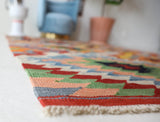 Vintage kilim rug in room decor setting, old rug, antique rug, pastel colors, faded colors, Turkish rug, vintage rug, soft rug, Portland, Oregon, rug store, rug shop, local shop, bold colors, bright colors, faded colors