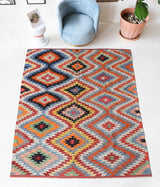 Vintage kilim rug in room decor setting, old rug, antique rug, pastel colors, faded colors, Turkish rug, vintage rug, soft rug, Portland, Oregon, rug store, rug shop, local shop, bold colors, bright colors, faded colors