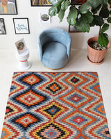 Vintage kilim rug in room decor setting, old rug, antique rug, pastel colors, faded colors, Turkish rug, vintage rug, soft rug, Portland, Oregon, rug store, rug shop, local shop, bold colors, bright colors, faded colors