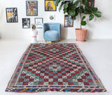 Vintage kilim rug in room decor setting, old rug, antique rug, pastel colors, faded colors, Turkish rug, vintage rug, soft rug, Portland, Oregon, rug store, rug shop, local shop, bold colors, bright colors, faded colors