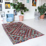 Vintage kilim rug in room decor setting, old rug, antique rug, pastel colors, faded colors, Turkish rug, vintage rug, soft rug, Portland, Oregon, rug store, rug shop, local shop, bold colors, bright colors, faded colors