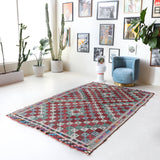 Vintage kilim rug in room decor setting, old rug, antique rug, pastel colors, faded colors, Turkish rug, vintage rug, soft rug, Portland, Oregon, rug store, rug shop, local shop, bold colors, bright colors, faded colors