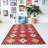Vintage kilim rug in room decor setting, old rug, antique rug, pastel colors, faded colors, Turkish rug, vintage rug, soft rug, Portland, Oregon, rug store, rug shop, local shop, bold colors, bright colors, faded colors