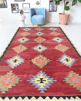 Vintage kilim rug in room decor setting, old rug, antique rug, pastel colors, faded colors, Turkish rug, vintage rug, soft rug, Portland, Oregon, rug store, rug shop, local shop, bold colors, bright colors, faded colors