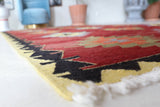 Vintage kilim rug in room decor setting, old rug, antique rug, pastel colors, faded colors, Turkish rug, vintage rug, soft rug, Portland, Oregon, rug store, rug shop, local shop, bold colors, bright colors, faded colors