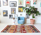 Vintage kilim rug in living room setting, old rug, antique rug, pastel colors, faded colors, Turkish rug, vintage rug, soft rug, Portland, Oregon, rug store, rug shop, local shop, earthy tones, earthy colors, warm colors